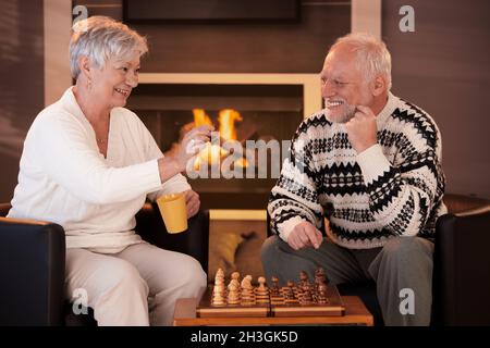 Happy senior couple playing chess Stock Photo