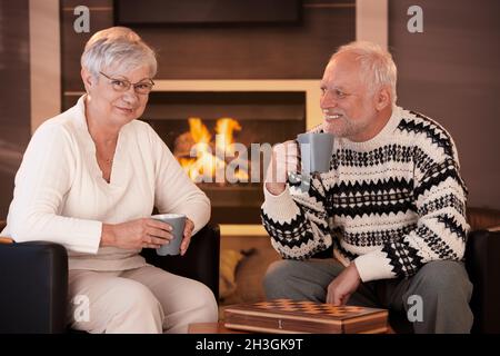 Happy senior couple on winter night at home Stock Photo