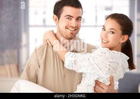 Young couple smiling happily holding each other Stock Photo