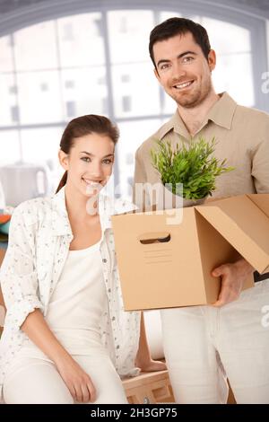 Happy couple unpacking boxes in new home Stock Photo