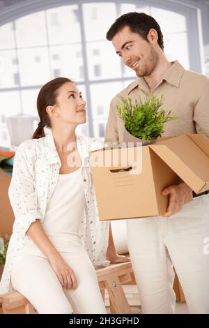Happy couple unpacking boxes in new home Stock Photo