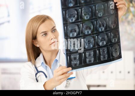 Young radiologist looking at x-ray image Stock Photo