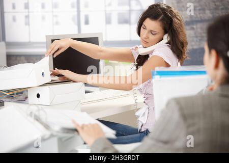 Young office worker on phone busy Stock Photo