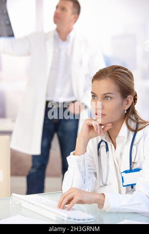 Young female doctor working on computer in office Stock Photo