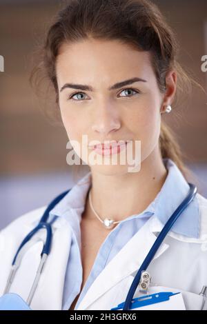 Portrait of young attractive female doctor smiling Stock Photo