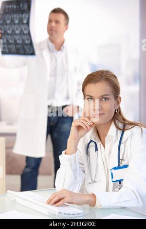 Attractive female doctor working on computer Stock Photo