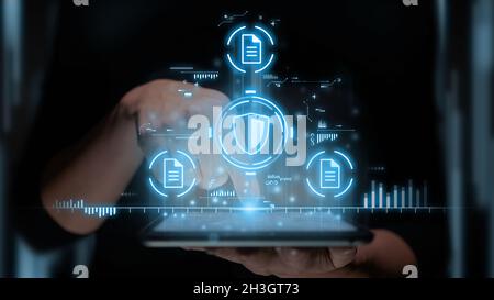 Insurance concept with online paperwork using tablet with shield and document icons. Stock Photo