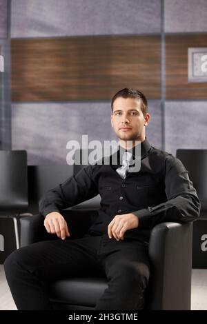 Young businessman sitting in meeting room Stock Photo