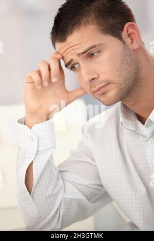 Goodlooking man having headache Stock Photo