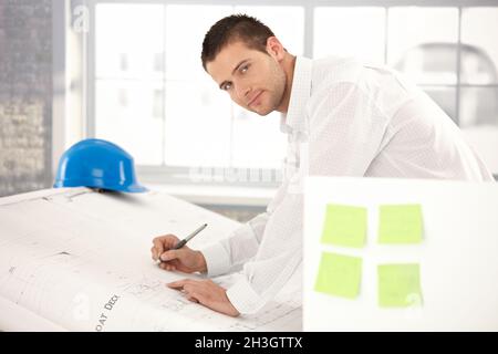 Handsome engineer drawing plans Stock Photo