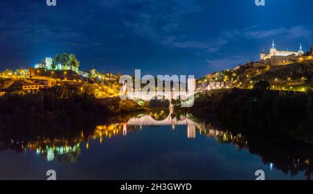 Night Panoramic view of the Alcázar de Toledo and the Castillo de San Servando across the Alcantara Bridge Stock Photo