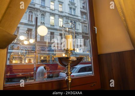 Vienna Austria - September 1 2017; Grainy old-world-image View from indoors through window with reflections of indoor lights to street and buildings i Stock Photo