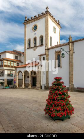 Bragança, Portugal - June 26, 2021: Bragança Cathedral Tower in Portugal, seen from the square with floral arrangement in the foreground. Stock Photo