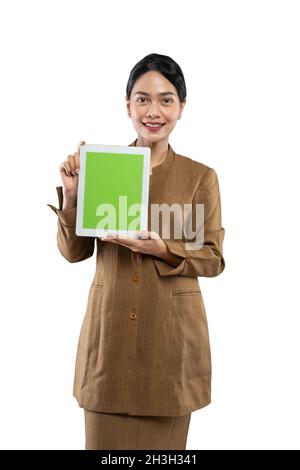 Attractive woman wearing khaki uniform smiling showing her tablet screen Stock Photo