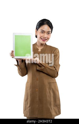 Attractive woman wearing khaki uniform smiling showing her tablet screen Stock Photo