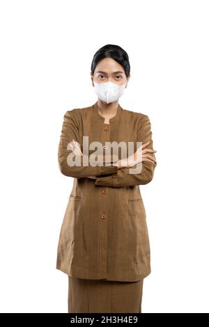 Indonesian woman in uniform wearing mask crossed arm Stock Photo