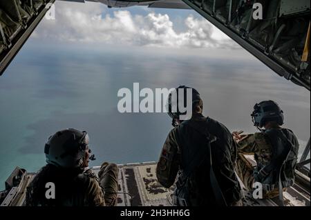 Senior Airman Savannah McCauley, 39th Airlift Squadron loadmaster, left, Senior Airman Chloe Lefebvre, 39th AS loadmaster, middle, and Senior Airman Dylan Turner, 317th Aircraft Maintenance Squadron crew chief, right, sit on the back ramp of a C-130J Super Hercules aircraft as part of Exercise Hazard Key, Oct. 13, 2021. The 317th AW continues to play a role in tactical airlift and humanitarian efforts for the U.S. Air Force. (U.S. Air Force photo by Senior Airman Reilly McGuire) Stock Photo