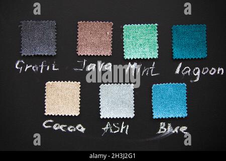 Samples of fabrics for sewing furniture on a dark background. Stock Photo