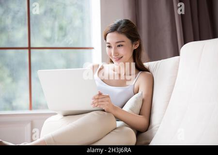 Young woman using a laptop computer Stock Photo
