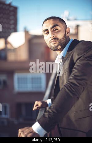 Confident attractive Arab businessman in urban environment Stock Photo