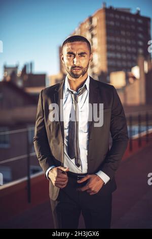 Confident attractive Arab businessman in urban environment Stock Photo