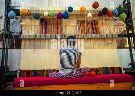 CAPPADOCIA - MAY 17 : Woman working at the manufacture of carpets, on May 17, 2013, in Cappadocia, Turkey. Turkish rugs are one Stock Photo