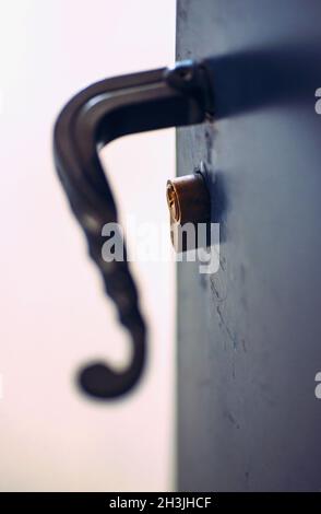 Opened metal door with latch handle closeup Stock Photo