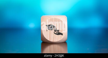 Wooden block with symbol of fafsa concept on blue background Stock Photo