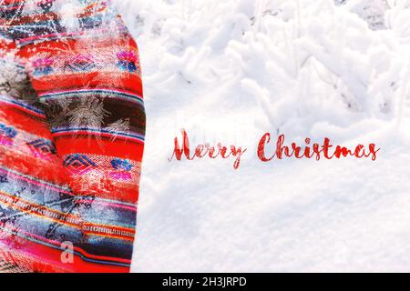 Festive Christmas holiday winter background with bright red tablecloth covered sparkling snowflakes on rustic wooden table. Frost pattern Stock Photo