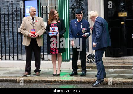 London, UK. 29th Oct, 2021. Prime Minister Boris Johnson meets with fundraisers for the Royal British Legion and purchases a poppy in front of Number 10 Downing Street, London Credit: Alan D West/Alamy Live News Stock Photo