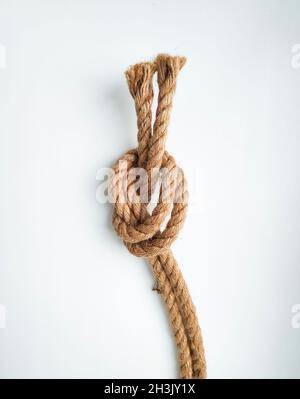 Knot made from natural rope cord isolated on white background Stock Photo