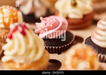 Sweet little cupcake with raspberry cream and sugar pearls as a decoration Stock Photo