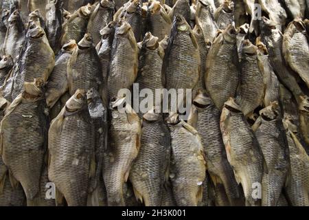 Dried fish on the table. Salty dry river fish as background, top view. Stock Photo