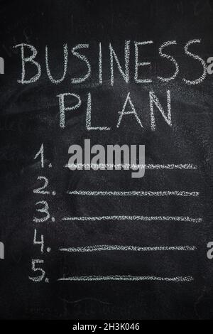 Business plan list on black chalkboard Stock Photo