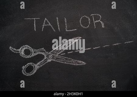 Scissors with cut line and tailor word on chalkboard Stock Photo