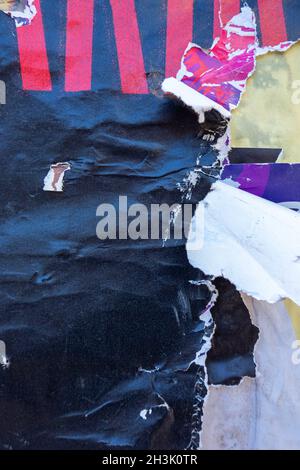 Old grunge ripped torn collage posters creased crumpled paper placard texture background Stock Photo