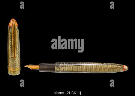 Old fountain pen on a black background with clipping path. Big copy space. Vintage fountain pen isolated on black Stock Photo