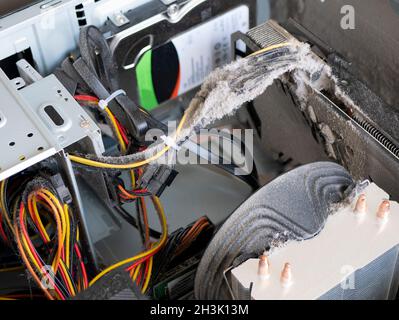 Dust in the personal computer case. Video card, cooler, cables and other computer components covered with heavy dust Stock Photo