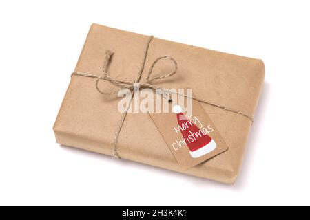Christmas gift box wrapped in kraft paper. Isolated on white background Stock Photo