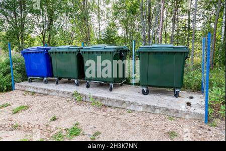 Plastic garbage containers at the outdoors in summer sunny day Stock Photo