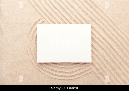Blank card mockup on sand background. Lines drawn on the sand. Top view. Minimal design - Image Stock Photo