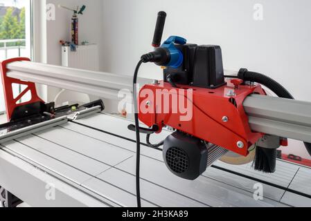 Cutter machine for ceramic tiles. A flat during renovation. Stock Photo