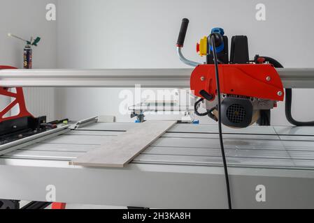 Cutter machine for ceramic tiles. A flat during renovation. Stock Photo