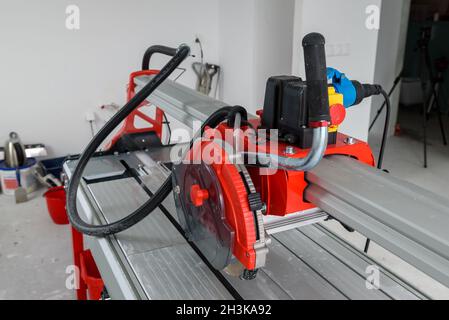 Cutter machine for ceramic tiles. A flat during renovation. Stock Photo