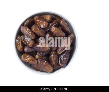 Full bowl of dried dates isolated on white background. Top view. Stock Photo