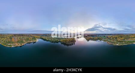 360 degree panoramic view of Aerial view of a sunset over a lake in forest