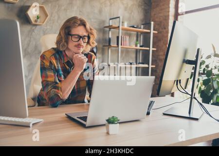 Photo of young man programmer look read browse computer virtual online job testing software website indoors Stock Photo