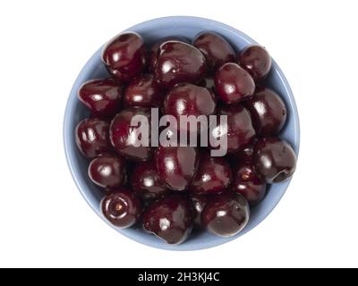 Fresh ripe cherries in bowl. Isolated on white background. Top view. Stock Photo
