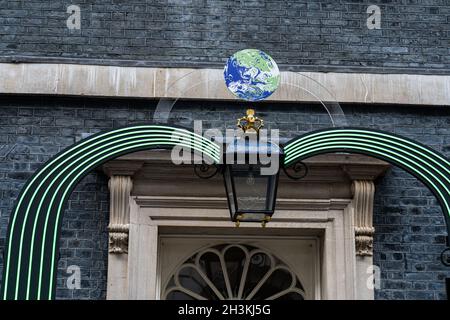LONDON, UK. 29 Oct, 2021. The door of 10 Downing street is decorated with green LED energy saving lights and a globe  ahead of the COP26 summit in Glasgow on Sunday.  The 2021 United Nations Climate Change Conference, also known as COP26, is the 26th United Nations Climate Change conference will bring leaders from over 150 counties  together to accelerate action towards the goals of the Paris Agreement and  held between 31 October and 12 November 2021, under the co-presidency of the United Kingdom and Italy to tackle global warming and climate crisis. Credit: amer ghazzal/Alamy Live News Stock Photo