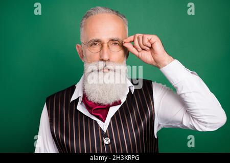 Photo of handsome calm bearded professor look camera wear glasses striped suit scarf on green color background Stock Photo